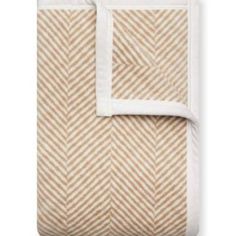 an image of a blanket with white and beige herringbones on the bottom,