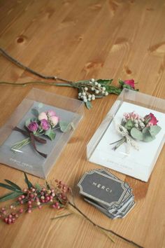 some flowers are laying on the floor next to cards and other things that have been placed around them