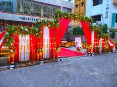 red and white decorated stage set up for an outdoor event with lights on the sides