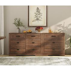 a large wooden dresser sitting in a living room next to a painting on the wall