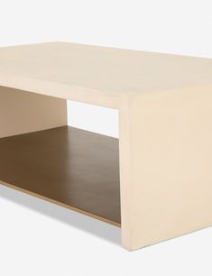 a white coffee table sitting on top of a wooden shelf