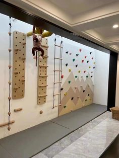 the climbing wall is made up of wooden pegs and ropes, along with other climbing equipment