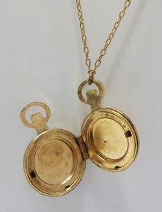 "Vintage 1928 brand pocket watch style locket pendant. 28\" chain with barrel fastener. Gold tone pocket watch style locket, including bale is 1 1/4\" x 3/4\". Hinged locket holds two photos. Gorgeous filigree design on the front of the locket & gold tone trim around the outer edge on the backside. This is in excellent vintage condition. Pre-owned & gorgeous! Signed with 1928 hang tag." Vintage Pocket Watch With Vintage Charm As Gift, Antique Nickel-free Locket Necklace Collectible, Vintage Gold Compact Pocket Watch, Antique Nickel-free Collectible Locket Necklace, Classic Antique Gold Locket Necklace With Vintage Charm, Vintage Compact Gold Pocket Watch, Compact Gold Vintage Pocket Watch, Vintage Compact Pocket Watch For Gift, Vintage Gold Pocket Watch Nickel Free