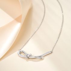 This necklace features a knot designed in the form of a ribbon, crafted with sterling silver. The delicate and elegant design of the pendant showcases the artistry and craftsmanship involved in its creation. The silky smooth texture of the ribbon adds a touch of sophistication to any outfit, making it a versatile accessory for both casual and formal occasions. This pendant necklace is a perfect choice for those who appreciate timeless elegance and desire to make a fashion statement.Carat Weight: Ribbon Knot, Knot Design, Outfit Making, Necklace Online, Anniversary Sale, Pretty Jewellery, Smooth Texture, Sterling Silver Necklace, Quality Jewelry