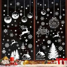 christmas window stickers with snowflakes and reindeers on them, hanging from the windows