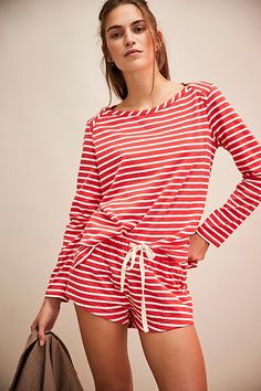 Perfectly paired in stripes, this cozy set from our free-est collection will be your go-to from this season to the next. **Fit:** Top: Relaxed, easy fit; Shorts: Low-slung, relaxed silhouette **Features:** Top: Wide neckline, vented hemline, striped pattern throughout; Shorts: Pull-on design, drawstring waist, side pockets **Why We ❤ It:** Easy on your day off or elevated with ballet flats and a sleek coat, this set has endless ways to wear. | Jenna Short Set by free-est at Free People in Red, S Red Cotton Loungewear Shorts, Striped Loungewear Shorts, Red Printed Loungewear Set, Casual Striped High-waisted Pajama Shorts, Striped Shorts With Built-in Shorts For Loungewear, Fiery Red, Set Free, Short Set, Lounge Set