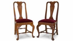 two wooden chairs with red upholstered seats