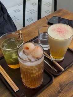 two drinks and chopsticks on a tray