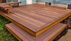 a wooden deck in front of a blue house