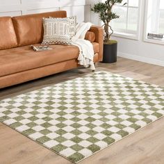 a living room with a brown couch and white rug