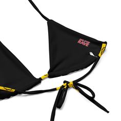 Hit the festival grounds in standout style with the Trippie Bikini Top. Splashed with a vibrant yellow and black smiley design, this top is all about comfort as you enjoy the music and vibes. •Its eco-friendly recycled fabric and UPF 50+ protection ensure you're all set for those sun-soaked festival days. • Adjustable Comfort: Crafted with flexible straps, find your perfect fit and style it. • Soft & Stretchy: The material moves with you so that you can dance and groove without a care. • Inclusi Black Rave Swimwear For Festivals, Black Rave Swimwear, Fitted Black Swimwear For Music Festival, Fun Festival Swimwear With Triangle Top, Fun Triangle Top Swimwear For Festivals, Black Summer Festival Swimwear, Rave Swimwear For Beach Festival, Rave Festival Swimwear For Beach Season, Rave Style Swimwear For Beach Festival