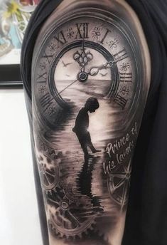 a man's arm with a clock and water scene tattoo on the left shoulder