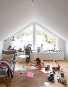 two people in a room with toys on the floor