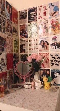 a room with many pictures and flowers on the wall