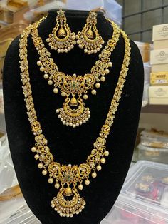 a necklace and earring set on display in a store