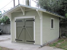 a small shed with two doors on the side