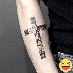 a man with a cross tattoo on his arm