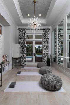 a large room with white walls and wooden flooring is decorated in black and white