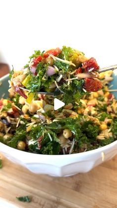 a white bowl filled with salad on top of a wooden table