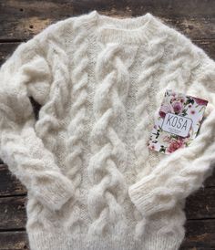 "White cable knit fluffy women pullover wiht round neck. Product Details: * 100% hand knit * 75% alpaca, 25% merino wool. Regular fit. Size: S(4-6) M(8-10) L(12-14) S Width : 46/48 cm Length: 58/60 cm M Width : 50/52 cm Length: 60 cm L Width : 54 cm Length: 62 cm Please let me know your size. It is made for order. If you would like me in other size, you could request a custom order with your own parameters: your height, bust and length of the sweater from the shoulder in cm. Or add your comments White Pullover, Wedding Jacket, Merino Sweater, Alpaca Sweater, Sweater White, Winter Sweater, Women Sweater, Pullover Sweater Women, Fitted Sweater