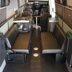 the inside of an airplane with seats and tables