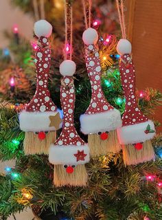 three christmas ornaments hanging from a tree