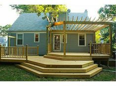 a house with a deck and pergolated roof