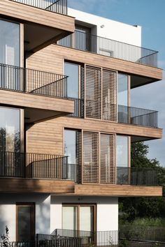 an apartment building with balconies on the second floor