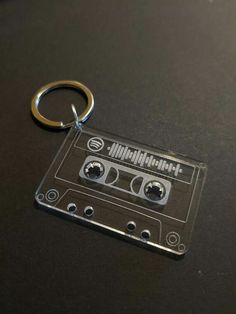 a keychain that has an old school cassette on it