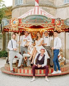 a group of people standing around a merry go round