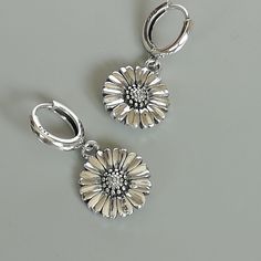 A PAIR of sterling silver hoops. Comes with a cute detachable sunflower charm. The charm is multipurpose and can be used with a neck or bracelet chain too. Dimension: Hoop- 12 mm Charm: 14 x 14 mm Drop length: 29 mm Weight: 6.80 gm Price listed is for a PAIR of hoops. These earrings are made of 925 hypoallergenic sterling silver Can be packaged in a gift box. I can include a personal message from you if needed You are welcome to contact me at... bhavnakwintra1956@gmail.com For more beautiful pie Sunflower Charm, Tiny Cross, Earrings Flower, Bracelet Chain, Sterling Silver Hoops, Star Charms, Silver Hoops, Bohemian Jewelry, Sterling Silver Charm