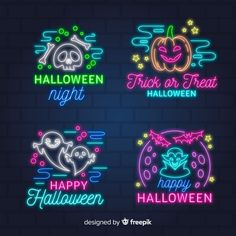 four neon signs for halloween on a brick wall