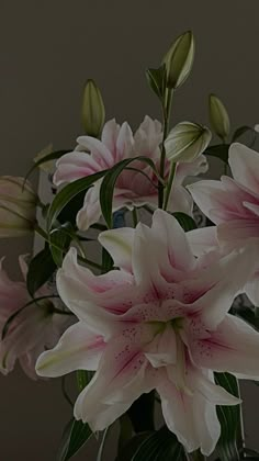 a vase filled with pink flowers on top of a table