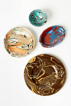 three marbled bowls sitting on top of each other