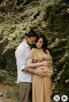 a pregnant couple standing next to each other