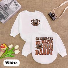 On Sundays We Watch with Daddy Romper Sweatshirt, Personalized Baby Football Shirt, Custom Toddler Fall Outfit, Cute Game Day Apparel ⭐ Product Description: * Handmade with Care: Each romper is handcrafted with attention to detail. * Ships from the USA: Quick and reliable shipping from our U.S.-based workshop. * High-Quality Materials: Made from 100% CPSIA Compliant and ethically sourced fabric. The light fabric (5.0 oz/yd² or 170 g/m²) ensures comfort and durability. * Soft and Breathable: Craf Crew Neck Tops With Letter Print For Playtime, White Cotton Sweatshirt For Playtime, Casual White Sweatshirt For Playtime, Family Matching White Long Sleeve Sweatshirt, Crew Neck Sweatshirt With Letter Print For Playtime, White Long Sleeve Family Matching Sweatshirt, White Long Sleeve T-shirt For Playtime, White Long Sleeve Sweatshirt For Family Matching, White Tops With Name Print For Playtime