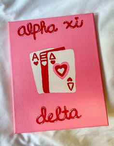 a pink canvas with the word delta written in red on it and an image of a deck of cards