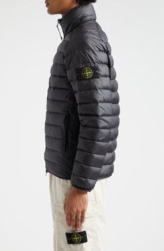 "Find STONE ISLAND Quiilted Nylon Down Puffer Jacket on Editorialist. A detachable compass badge affixed to the left arm adds the Italian label's signature touch to a channel-quilted puffer jacket insulated with ultraplush down. 25\" length (size Small) Two-way front-zip closure Stand collar On-seam zip pockets Lined, with duck down fill 100% nylon Made in Vietnam Designer Clothing" Outdoor Nylon Outerwear With Logo Patch, Fall Nylon Outerwear With Logo Patch, Nylon Outerwear With Logo Patch For Outdoor, Designer Nylon Outerwear For Outdoor, Stone Island Shirt, Stone Island Jacket, Down Puffer Jacket, Color Block Jacket, Quilted Puffer Jacket