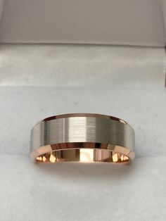 a gold wedding band in a box