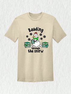 Imagine yourself at the library during the holiday season, surrounded by shelves lined with books. As you make your way through the stacks, you stumble upon a t-shirt that perfectly captures the magic of Christmas and the love for reading. Our Christmas Reading Through The Snow Shirt is the perfect gift for teachers and bookworms alike. Get ready to show off your love for books with this delightful and festive tee.Christmas Reading Through The Snow Shirt, Christmas Library T-Shirt, Bookworm Christmas Tee, Gift For Teachers Sand Casual  Short Sleeve  Animal,Cartoon,Christmas,Colorblock,Figure,Geometric,Graphic,Letter,Striped,Plants,Slogan,Textured Pattern    Women Clothing, size features are:Bust: ,Length: ,Sleeve Length: Christmas Library, Christmas Reading, Stand Collar Top, Cartoon Christmas, Cute Letters, Magic Of Christmas, Animal Cartoon, Geometric Graphic, Grey Baby