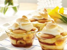 three desserts are sitting on a plate with flowers in the backgroung