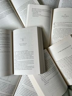 several open books laying on top of each other in the shape of a circle,