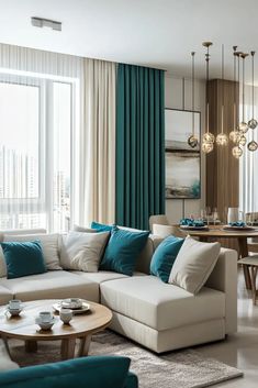 a living room filled with furniture next to a large window covered in blue and white curtains