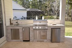 an outdoor kitchen with stainless steel appliances