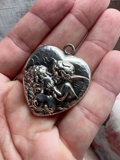 Amazing Unger Brothers locket in their most famous Love's Dream pattern with Cupid Kissing Psyche. Their heart lockets are hard to come by and feature the Unger Bros Logo in the top. It is amazing Repousse work! It is over 120 years old so please keep in mind when purchasing. The hinge and clasp work great it closes with a snap. It does require delicate handling due to age.  Unger Brothers are regarded as some of the best early American Silversmiths. Their items are highly collectible and retain value as this locket is likely over 120 years old. It would make for a wonderful heirloom with lots of history.   This Unger Bros Art Nouveau locket is featured in the Unger Bros catalogs with all of their locket designs. It's dated from late 1800s to early 1900s. It's in Amazing condition for the Victorian Jewelry With Heart Charm For Anniversary, Victorian Heart-shaped Charms Jewelry, Victorian Heart Charms Jewelry, Antique Double Heart Jewelry For Anniversary, Hallmarked Heart-shaped Victorian Jewelry, Victorian Heart-shaped Hallmarked Jewelry, Collectible Heart-shaped Locket Jewelry, Victorian Jewelry With Heart Charm As Keepsake, Victorian Locket Jewelry For Anniversary Gift