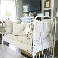 a living room with a white couch and some pictures on the wall