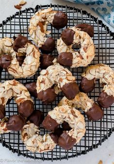 chocolate covered cookies and nuts on a cooling rack