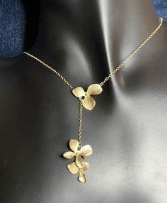 Orchids glide along 18K gold Filled necklace.  Gold plated orchids make an appearance on this handcrafted Lariat. Orchids may be all three together or separate to convert it into a lariat necklace. It can be dress up or down. Gorgeous! Perfect for all occasions. This necklace is very popular for weddings, and Proms,   Do you needed customized? Make changes while placing your order. Gold Filled Necklace, Lariat Necklace, Spring Rings, Necklace Gold, Handcrafted Jewelry, Orchids, San Diego, Gold Filled, Diamond Necklace