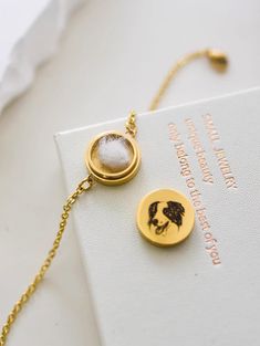 a close up of a book with a necklace on it