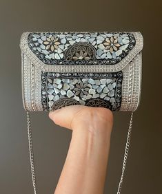 Step out in timeless elegance with our handcrafted Mosaic Mother-of-Pearl Evening Clutch. Each piece of shimmering mother-of-pearl has been carefully arranged to create a stunning mosaic that catches the light with every movement, ensuring you'll be the center of attention. Key Features: Exquisite Mosaic Design: Hand-laid mother-of-pearl pieces form a unique and captivating pattern. Vintage Charm: The clutch boasts intricate metalwork with an antique silver finish, adding a touch of bygone glamour. Versatile Carry: Comes with a delicate chain strap, allowing it to be carried as a shoulder bag or held as a clutch. Secure Fastening: A robust and stylish clasp keeps your valuables safe while on the move. Spacious Interior: Despite its compact appearance, the interior is surprisingly roomy, wi Sling Bag Pattern, Crochet Sling Bag, Vintage Evening Bags, Handmade Clutch, Mosaic Design, Clutches For Women, Mosaic Pattern, Designer Clutch, Crochet Bags Purses